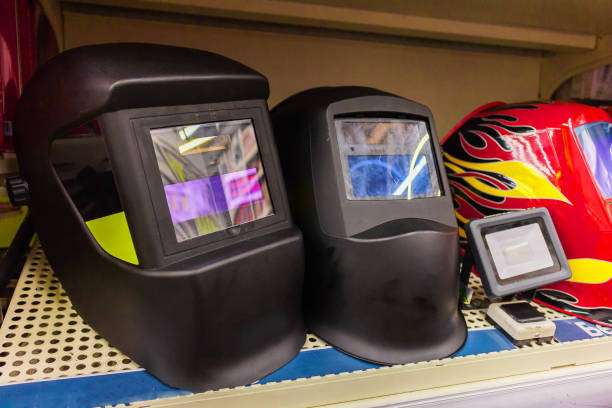 Close-up of black welding helmet and red flame design.
