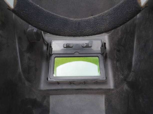Close-up of the auto-darkening lens inside a professional welding helmet.